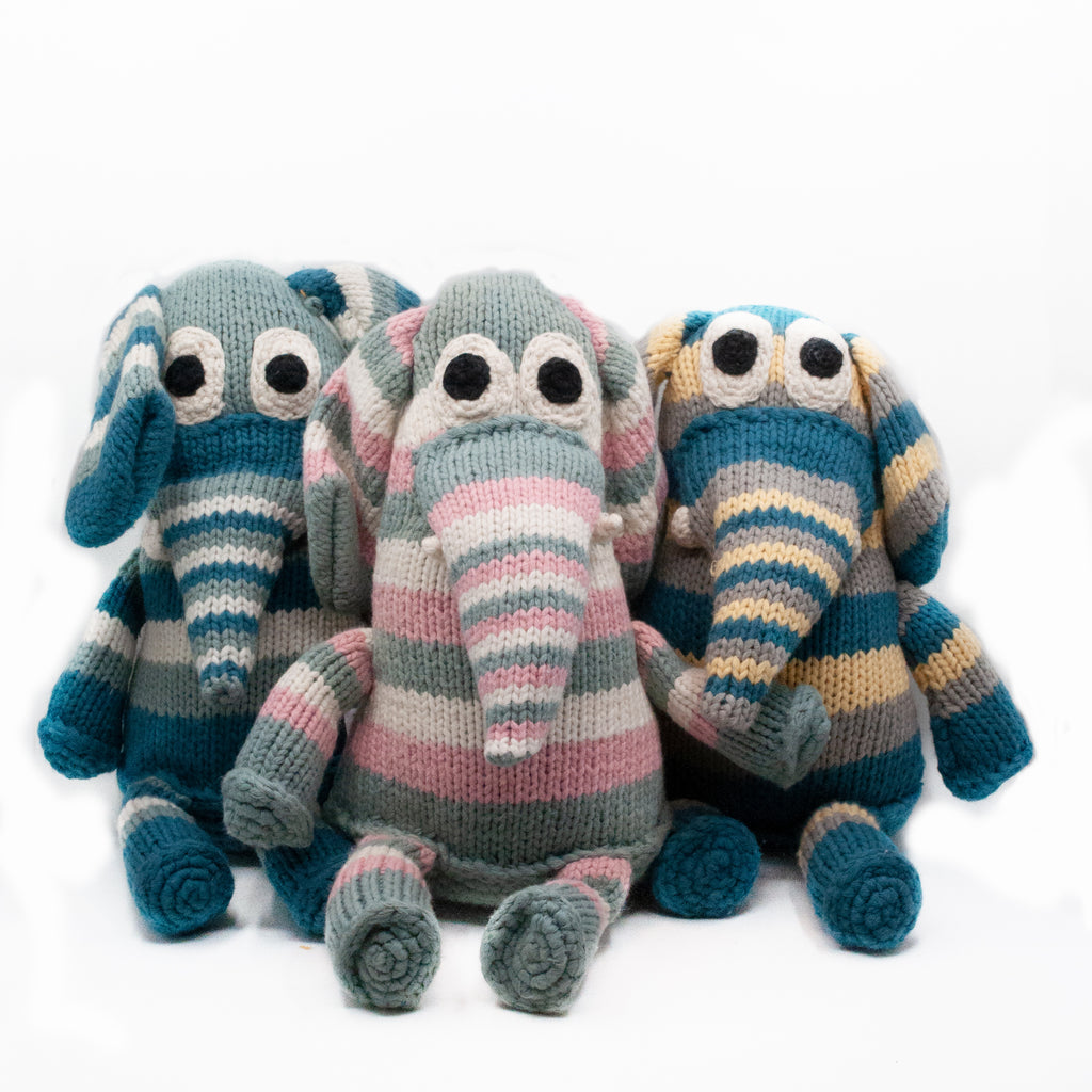 three snuggle elephants side by side. blue, pink and blue and yellow