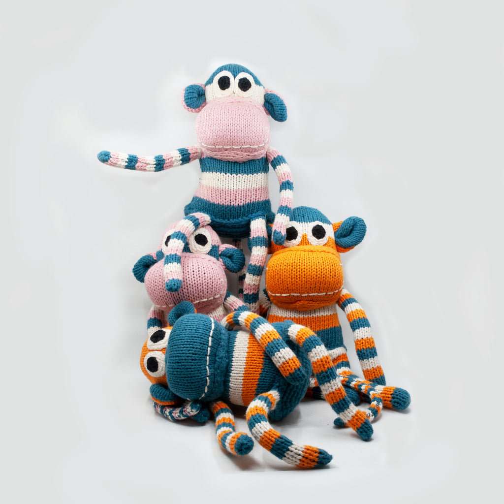 troop of 4 adorable hand knit snuggly monkey stuffed toys in colours of pink, blue and white stripes and orange blue and white stripes