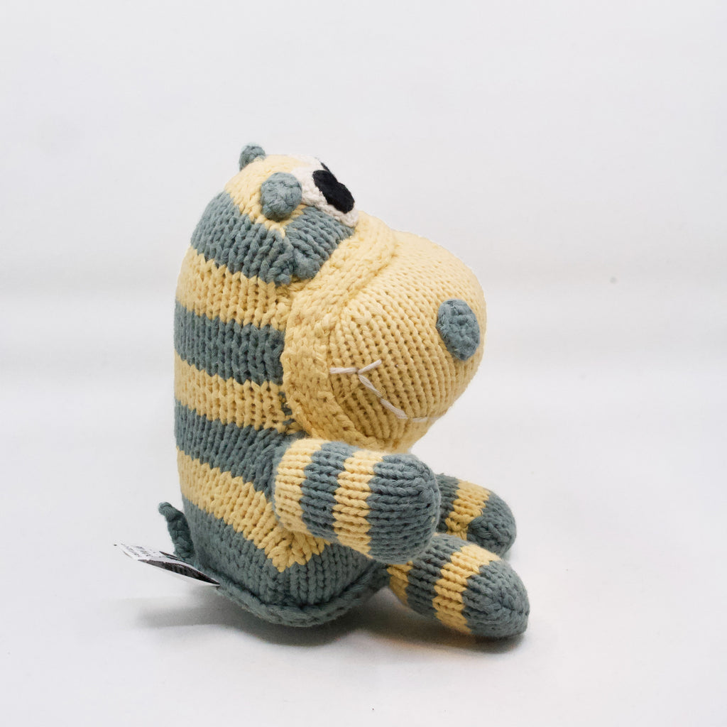 side view of snuggly artisan knit hippo in light blue and yellow
