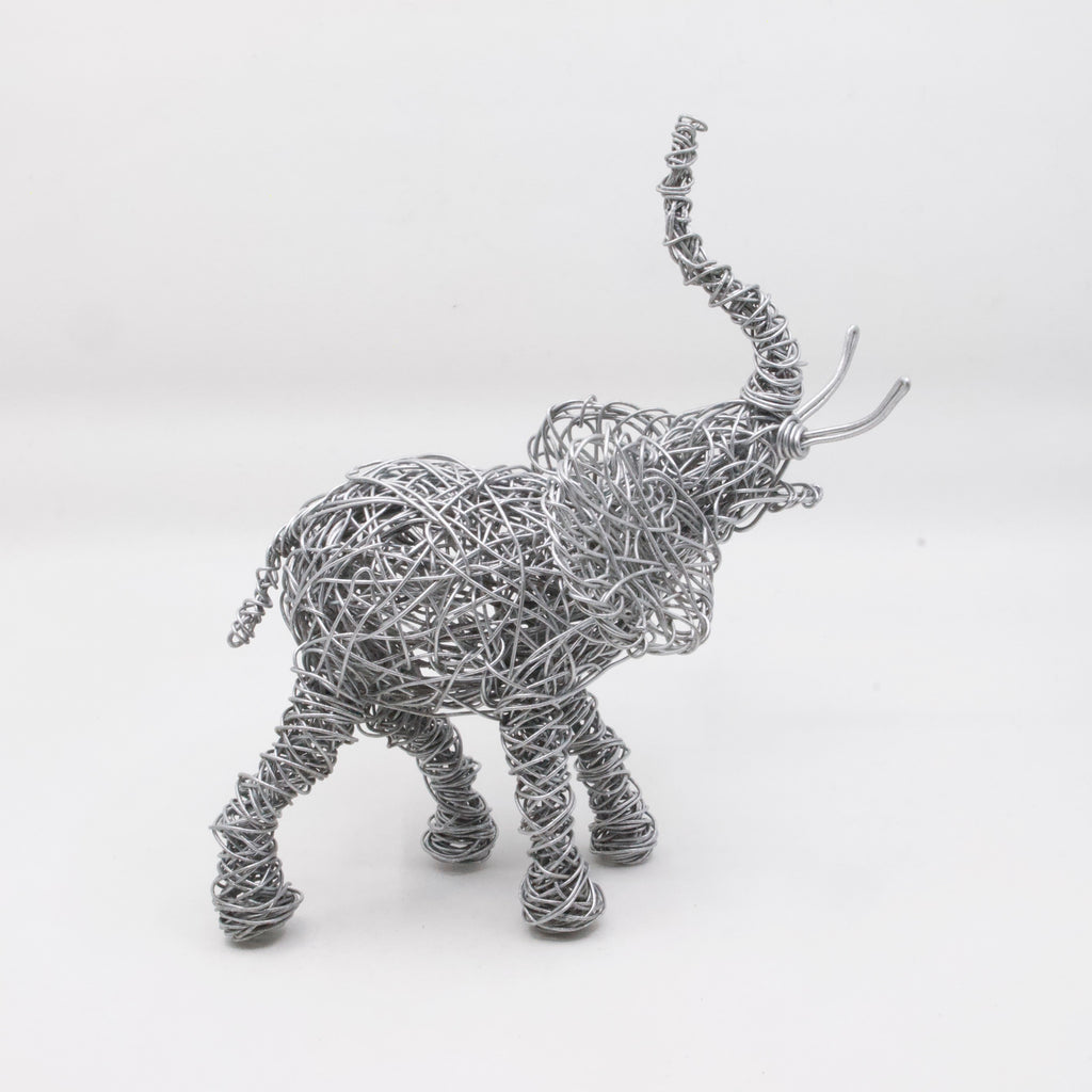 side view of hand twisted galvanized wire art elephant  with trunk up