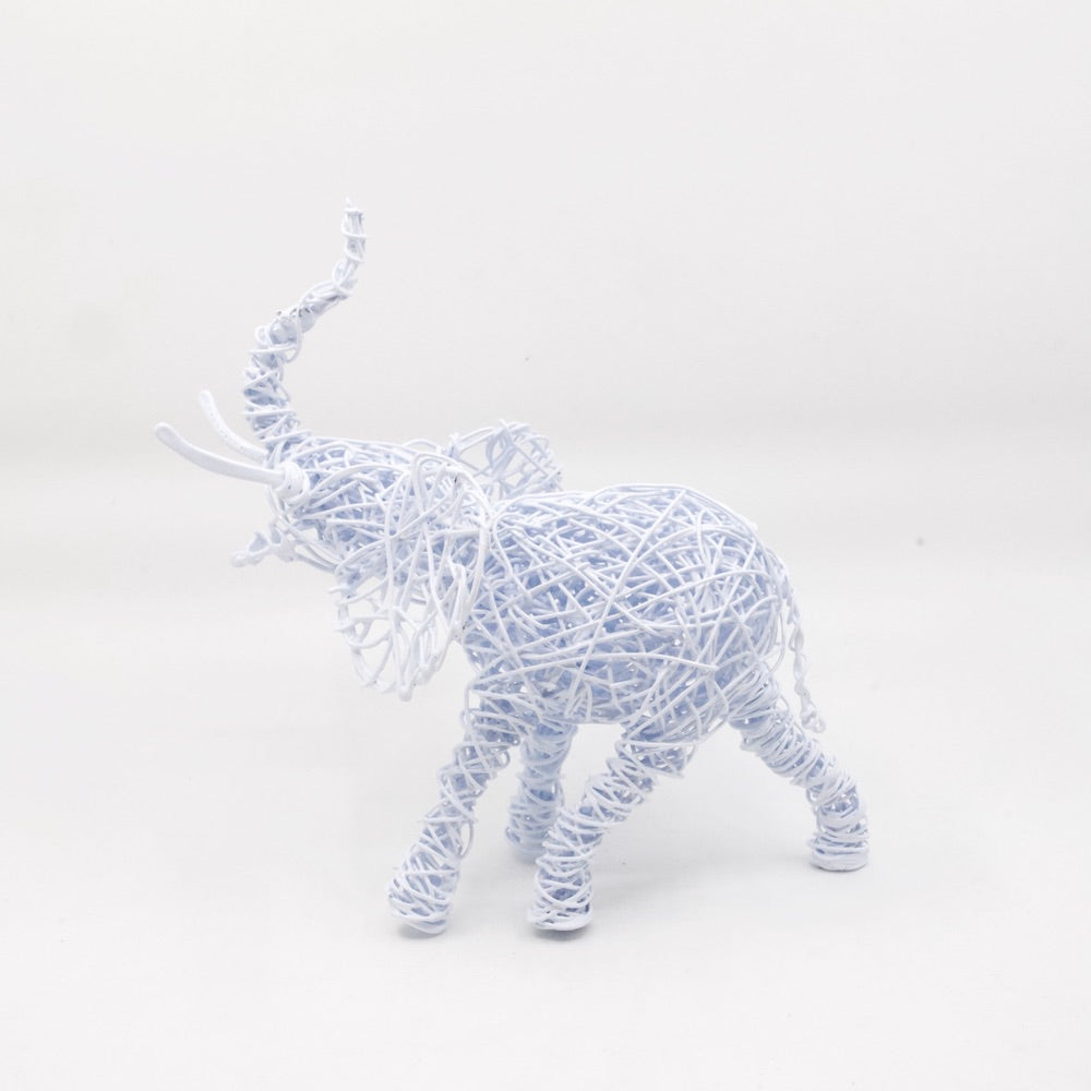 side view of hand twisted galvanized wire art elephant in powder coated white with trunk up