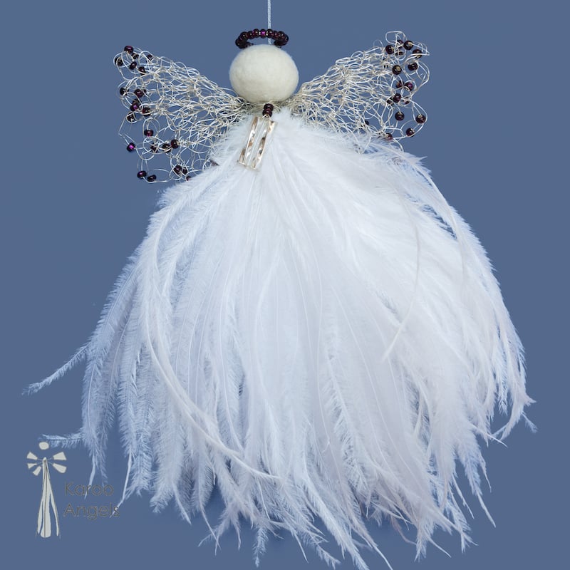 delicate guardian angel decoration with a white feather bodice, intricate wire double wings with dark purple beads and a felted wool head with a dark purple beaded halo