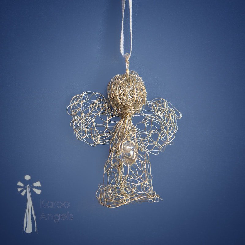 Tiny and delicate  Karoo Angels Juweel Angel Pendant. Made of knit silver coloured copper wire inset with small preciosia crystal bead. comes with silk tie matching the colour of the wire.  Size is 2.5 cm tall