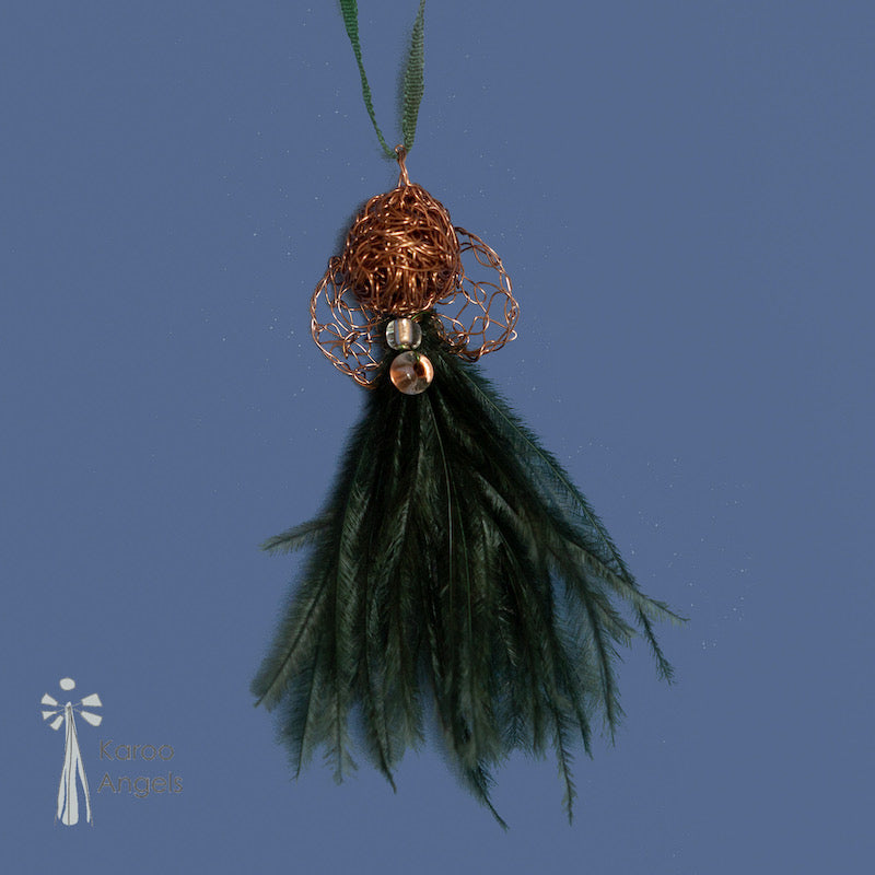 Tiny and delicate Karoo Angels Juweel Angel Pendant. Made of crocheted amber coloured coated copper wire adorned with a small preciosia crystal bead and dark green ostrich feathers. It hangs off a silk tie matching the colour of the wire.  Size 3.5cm