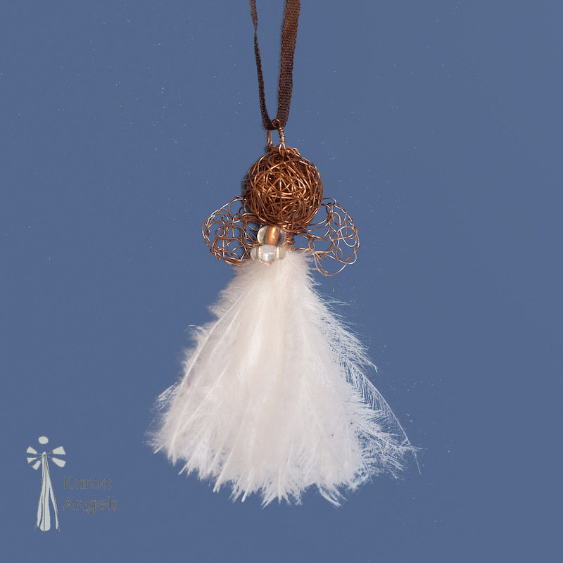 Tiny and delicate Karoo Angels Juweel Angel Pendant. Made of crocheted amber coloured coated copper wire adorned with a small preciosia crystal bead and white ostrich feathers. It hangs off a silk tie matching the colour of the wire.  Size 3.5cm