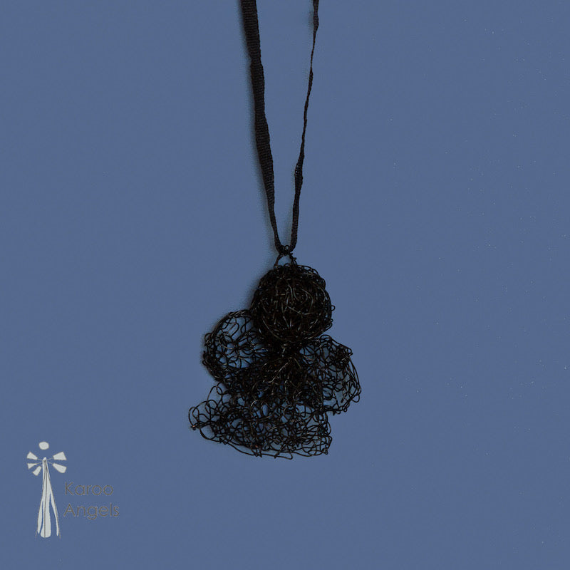 Tiny and delicate Karoo Angels Juweel Angel Pendant. Made of knit ink black coloured coated copper wire inset with small preciosia crystal bead. comes with silk tie matching the colour of the wire. Size 2.5cm high