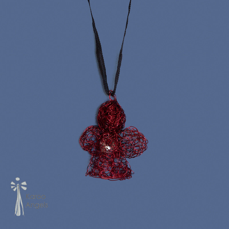 Tiny and delicate Karoo Angels Juweel Angel Pendant. Made of knit scarlet red coloured coated copper wire inset with small preciosia crystal bead. comes with silk tie matching the colour of the wire. size 2.5 cm high