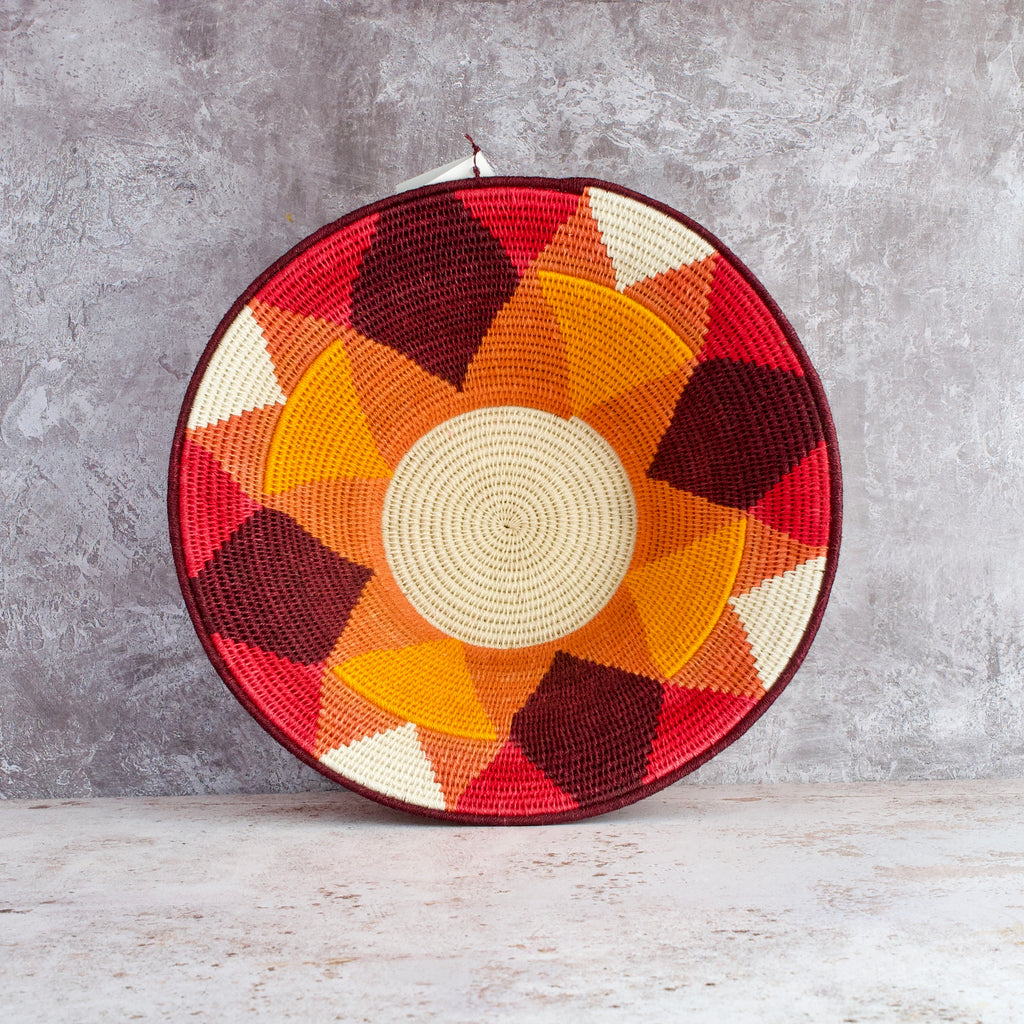 inside of large hand woven sisal basket. sundial pattern. summer of love mixed colours of cream, mango,coral, fuscia, aubergine