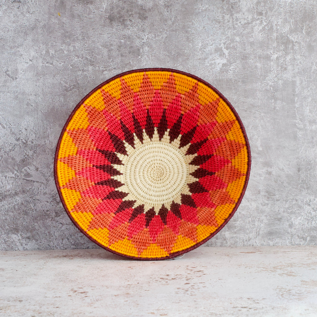 inside view of a medium size hand woven sisal basket. Diamond pattern. summer of love mixed colours of cream, mango,coral, fuscia, aubergine