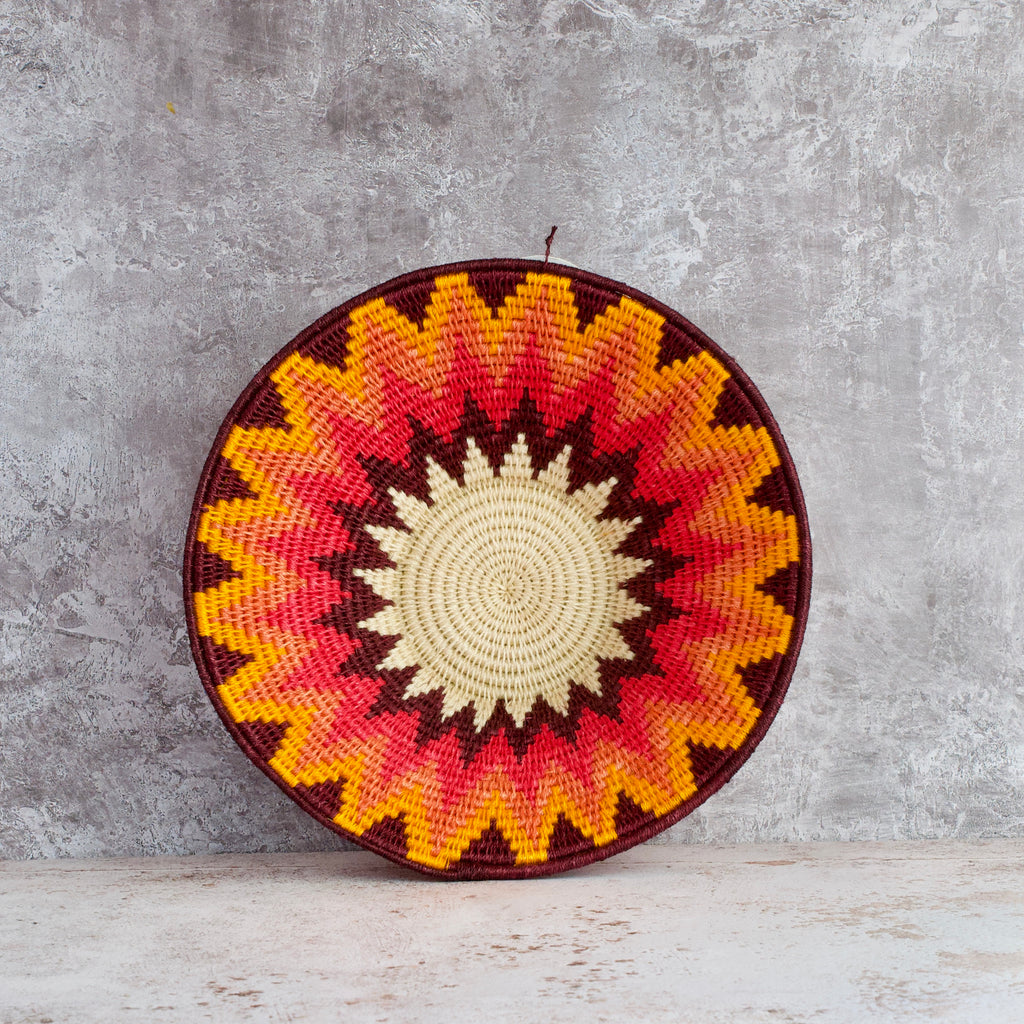 inside view of medium hand woven sisal basket. Protea pattern. summer of love mixed colours of cream, mango,coral, fuscia, aubergine