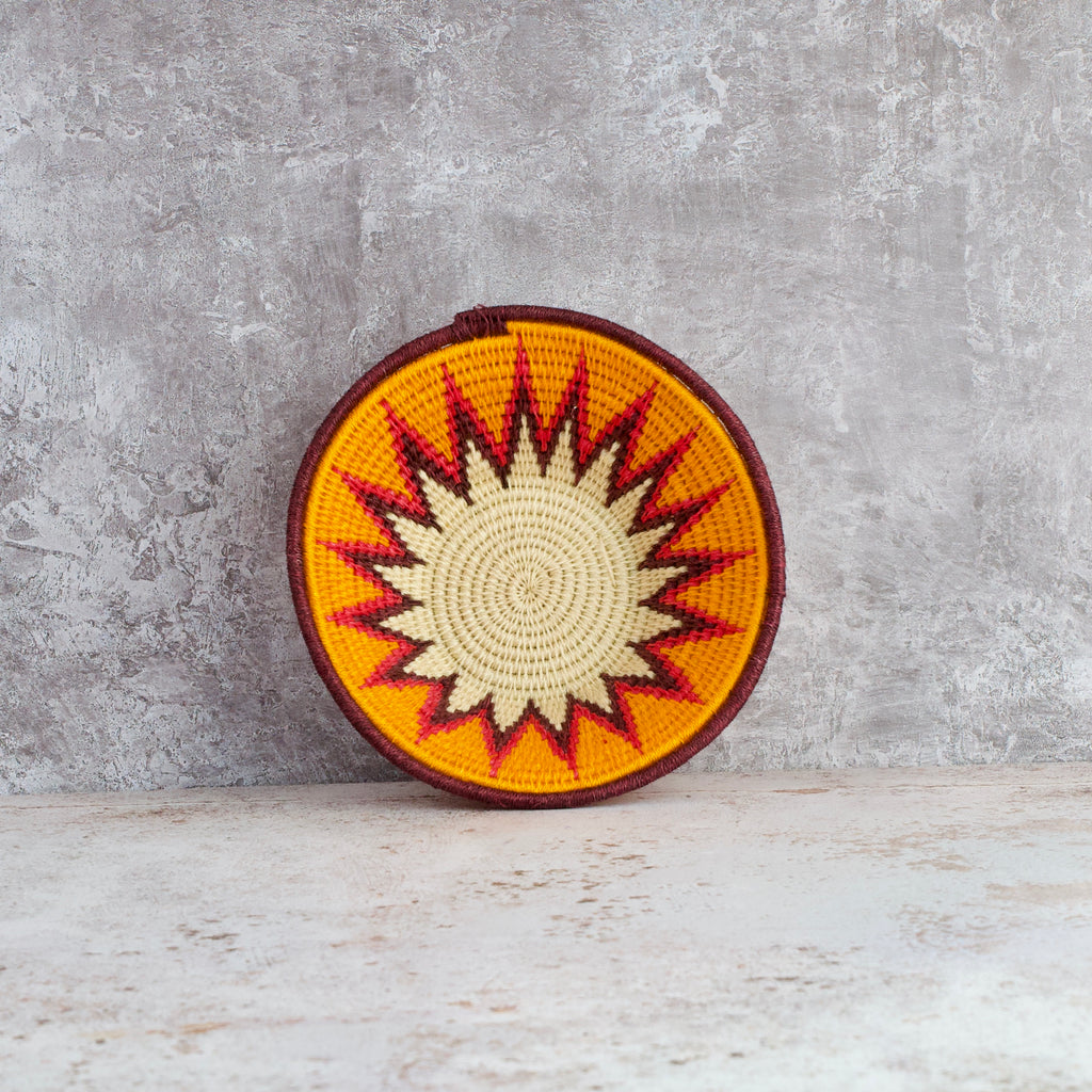 inside view of small hand woven sisal basket. Protea pattern. summer of love mixed colours of cream, mango,coral, fuscia, aubergine