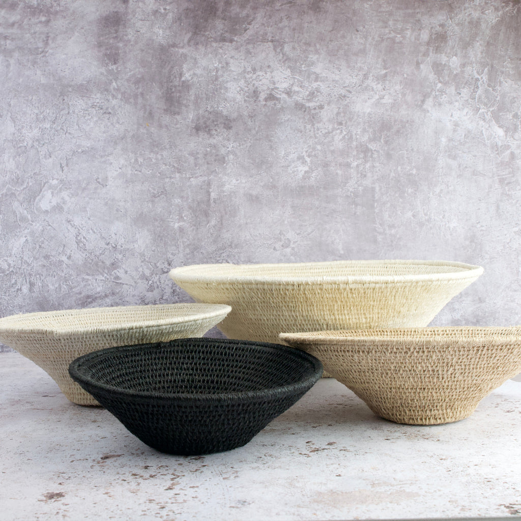 hand woven sisal baskets. pairing of 3 natural tone and one black